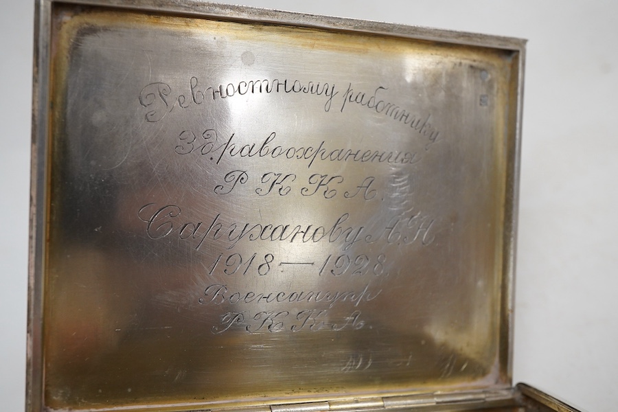 An engine turned 800 standard white metal cigarette case, 12cm, a 1920's Russian 875 standard white metal cigarette case and a white metal paper knife or page turner.